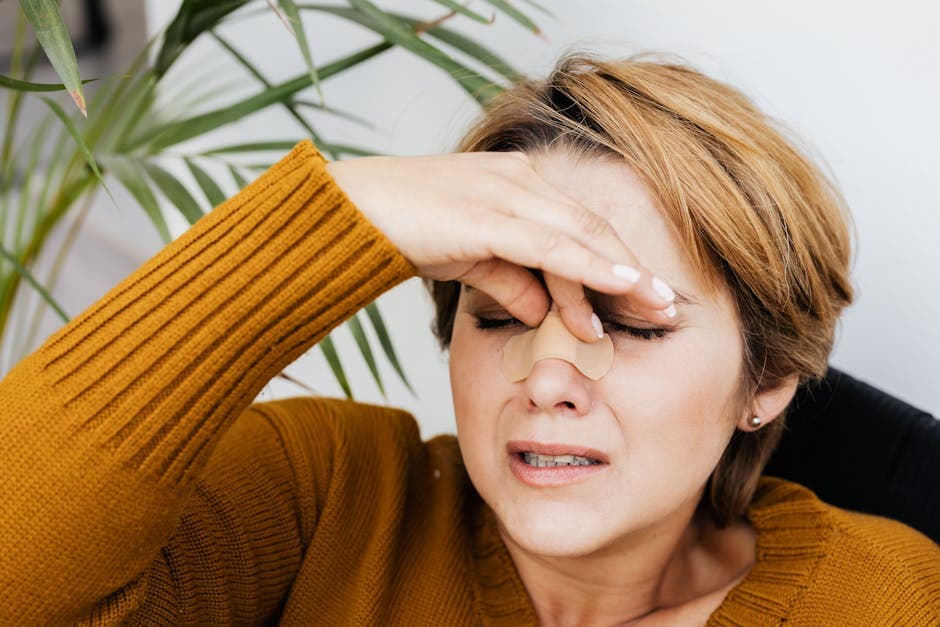 Woman experiencing dry eye symptoms — irritation, dryness and discomfort that can be treated by an ophthalmologist